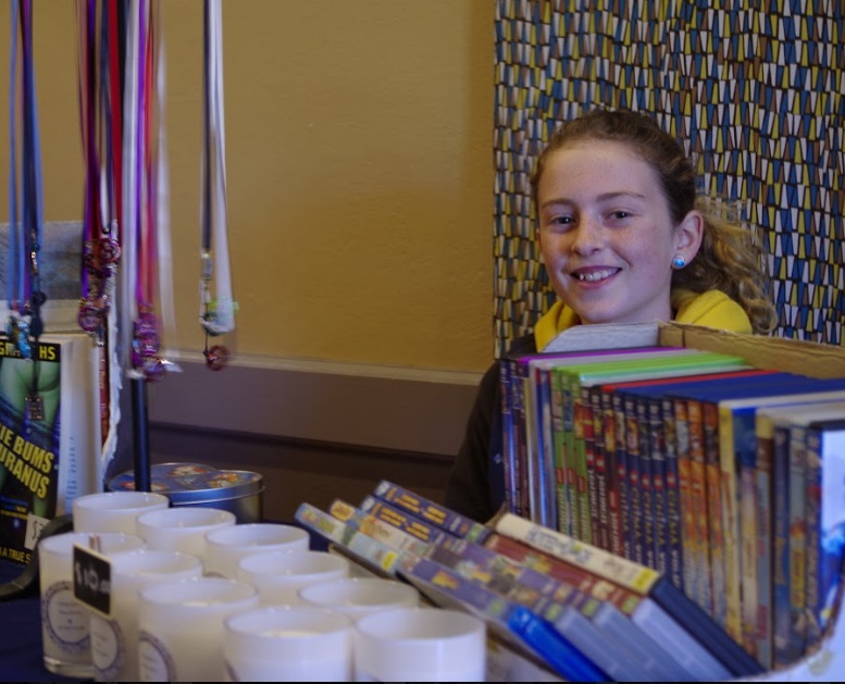Photograph of a young girl at a stall